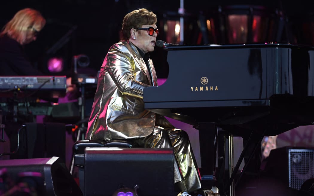 British singer Elton John performs on the Pyramid Stage during the 5th day of the Glastonbury festival in the village of Pilton in Somerset, southwest England, on June 25, 2023. Elton John closes the Glastonbury Festival in Britain on Sunday in what it is said to be his last work in the UK.  The 76-year-old singer is ending an exciting career with a farewell world tour, having played his last concerts in the United States in May before a final gig in Stockholm on July 8. (Photo by Oli SCARFF / AFP )