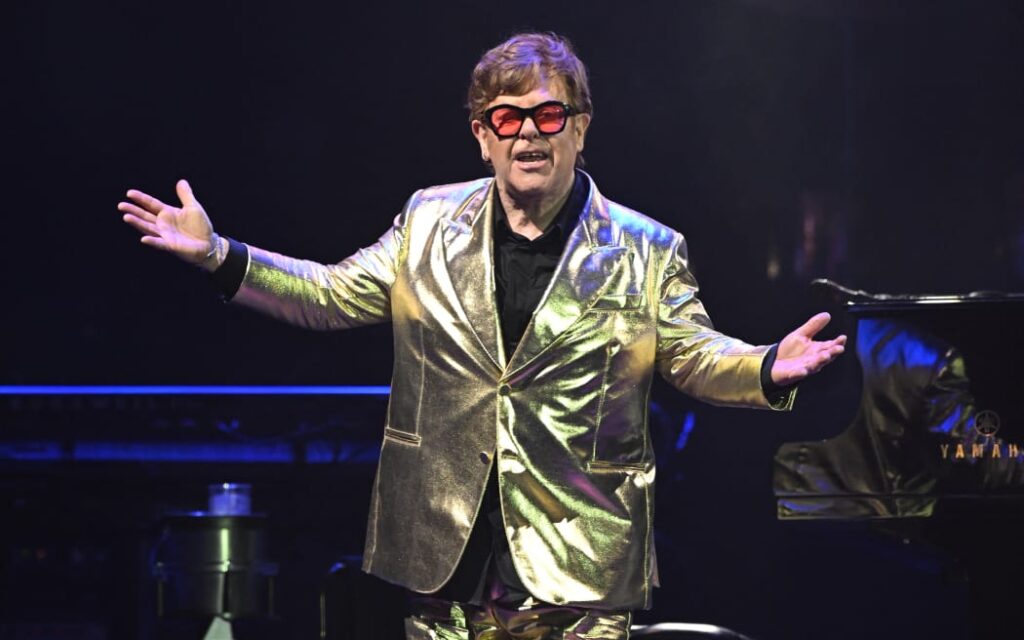 British singer Elton John performs on the Pyramid Stage during the 5th day of the Glastonbury festival in the village of Pilton in Somerset, southwest England, on June 25, 2023. Elton John closes the Glastonbury Festival in Britain on Sunday in what it is said to be his last work in the UK.  The 76-year-old singer is ending an exciting career with a farewell world tour, having played his last concerts in the United States in May before a final gig in Stockholm on July 8. (Photo by Oli SCARFF / AFP )