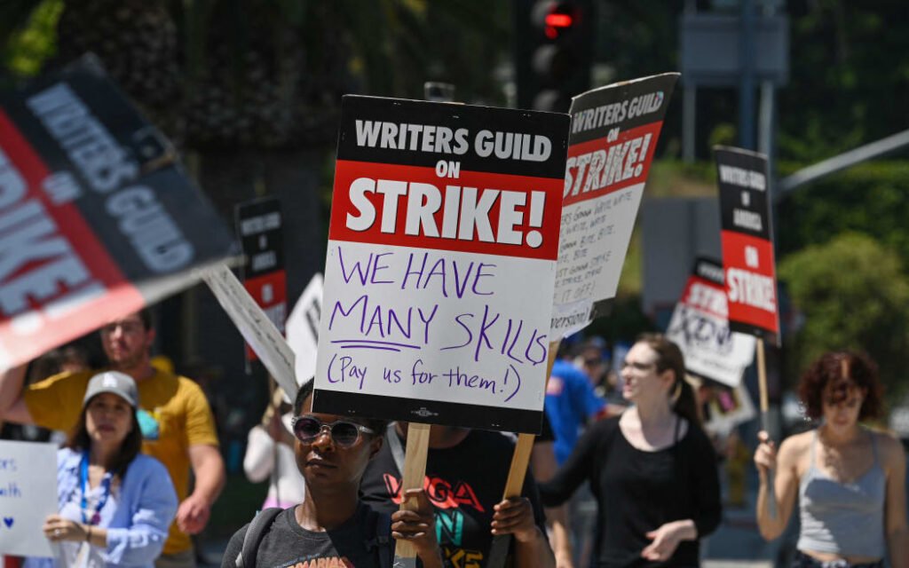 Hollywood writers and their fans line up outside Universal Studios Hollywood in Los Angeles, California, June 30, 2023. The summer of discontent in Hollywood could be on the rise this week, as actors and actresses are poised to join writers on the big screen. "to strike twice" which would cause nearly all US movies to be suspended.  The Screen Actors Guild (SAG-AFTRA) is locked in last-minute negotiations with the likes of Netflix and Disney, with the deadline approaching midnight on Friday (0700 GMT Saturday).  (Photo by Robyn Beck/AFP)